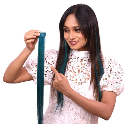 Woman holding a blue hair extension against her own hair on a white background